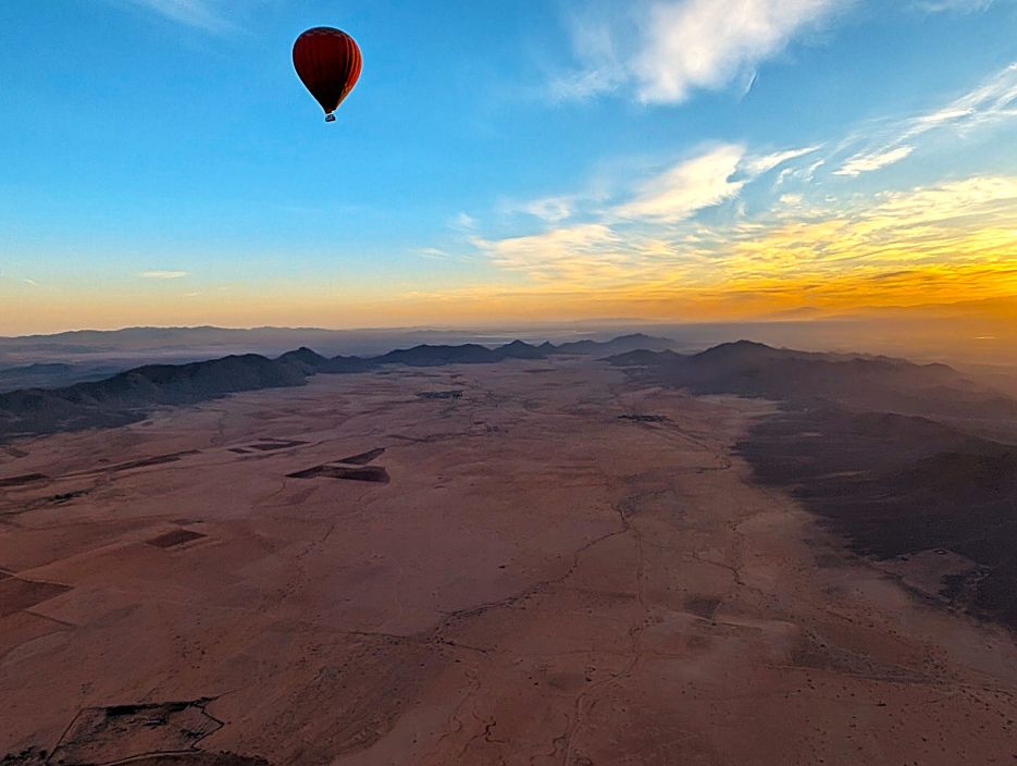 Hot‑air balloon rising before sunrise in Morocco